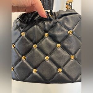 NWT Ted Baker Emily Rosette Bucket Bag in Black w/ gold metal detailing.